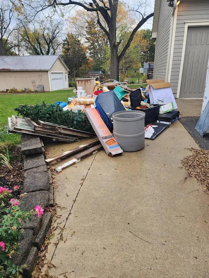 Dumpster being loaded with debris for Estate Cleanout Dumpster Rental in Waterford